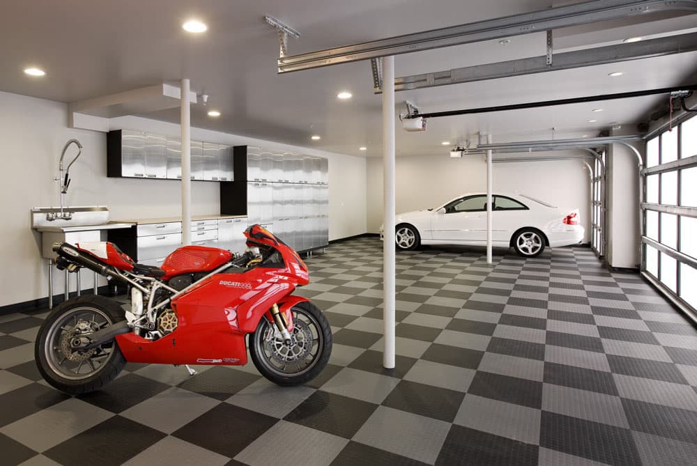 A ducati 999S and white car in garage with multiple light sources